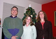 Doug, Loren, Patti in front of the Christmas tree.